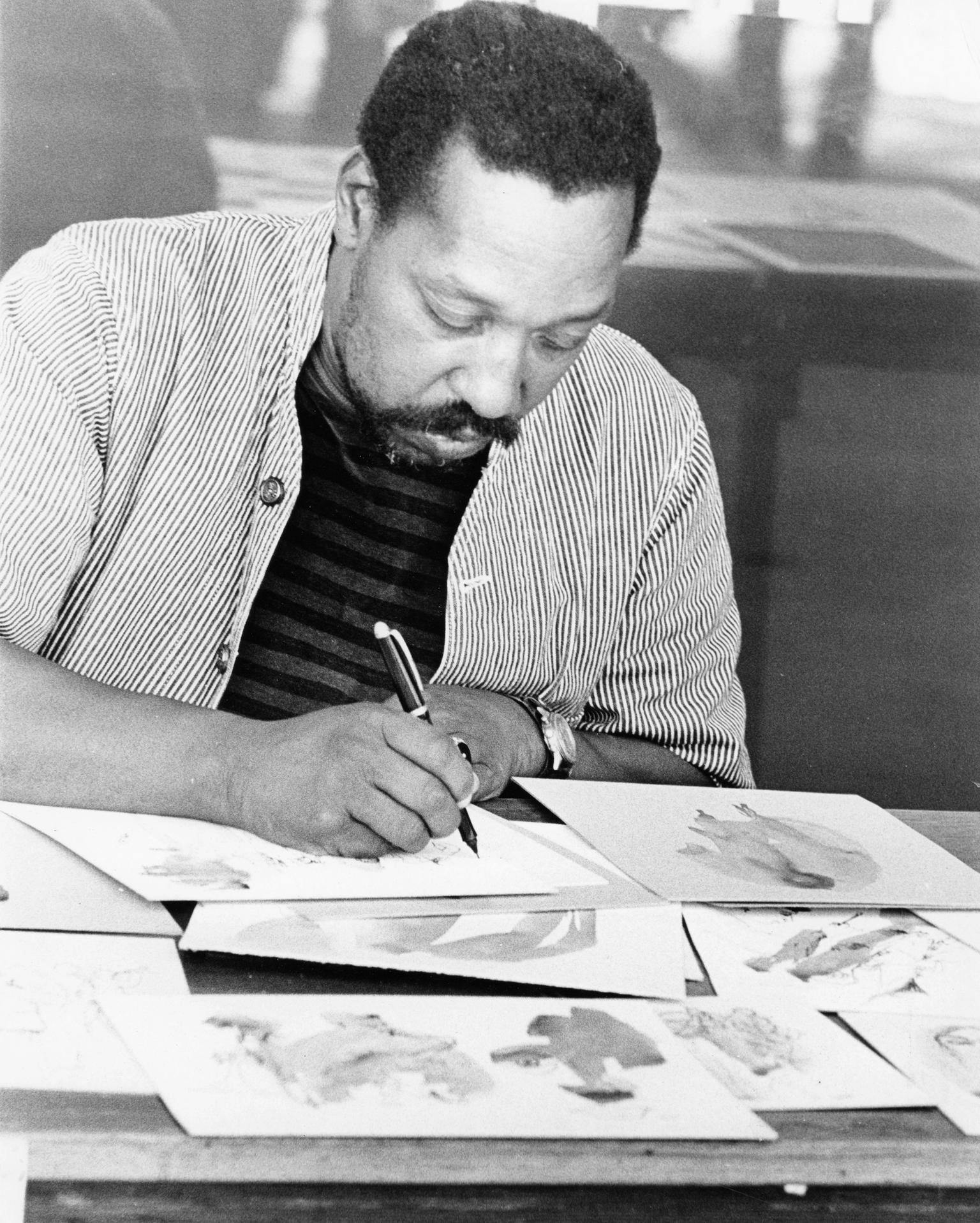 A black and white photo of a man drawing